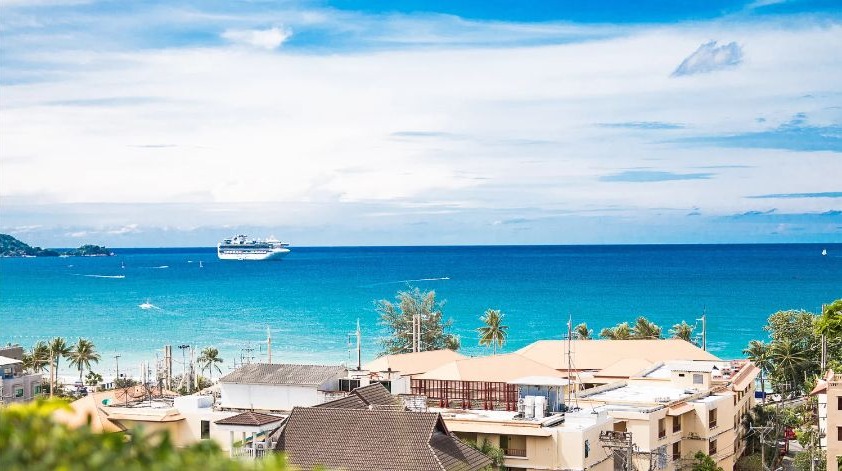 Phuket beachfront with turquoise Andaman Sea and resort coastline — MICE events and conference destination in Thailand