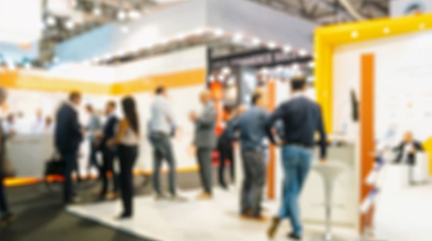 Busy trade show exhibition floor with booths and delegates networking in Thailand